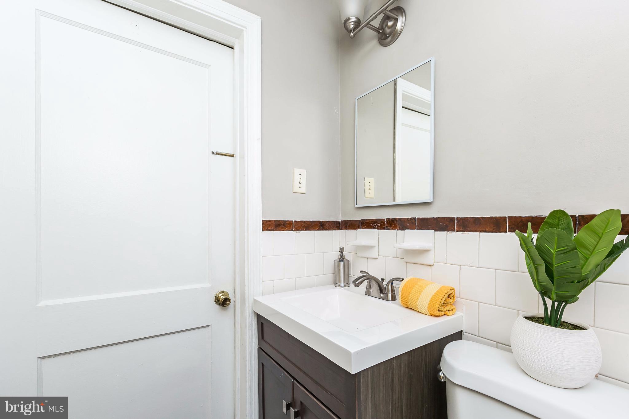 4016 Rexmere Road Baltimore, MD 21218 - Photo 11 of 26 a bathroom with a sink a mirror and a shower