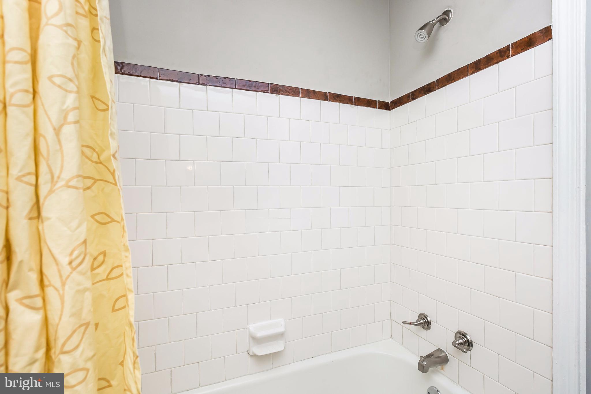 4016 Rexmere Road Baltimore, MD 21218 - Photo 12 of 26 a bathroom with a shower and a bathtub in it