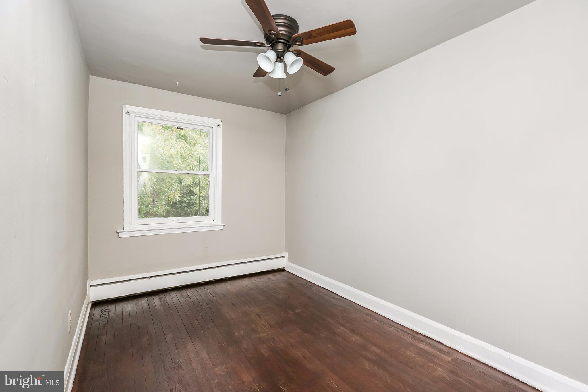 4016 Rexmere Road Baltimore, MD 21218 - Photo 13 of 26 an empty room with a window and a ceiling fan