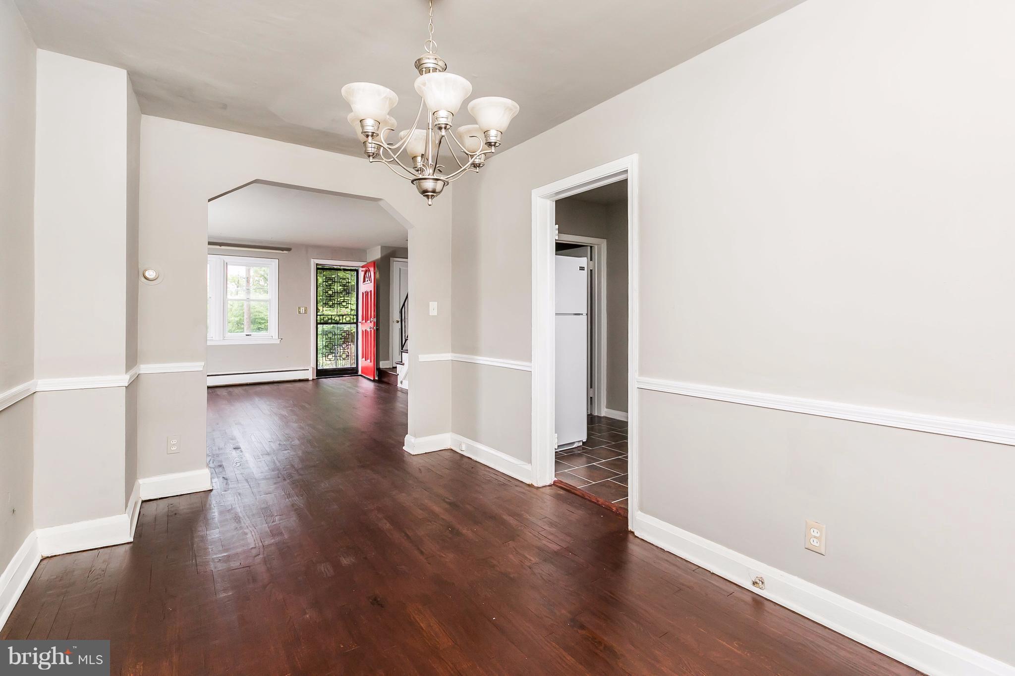 4016 Rexmere Road Baltimore, MD 21218 - Photo 4 of 26 wooden floor in an empty room with a window