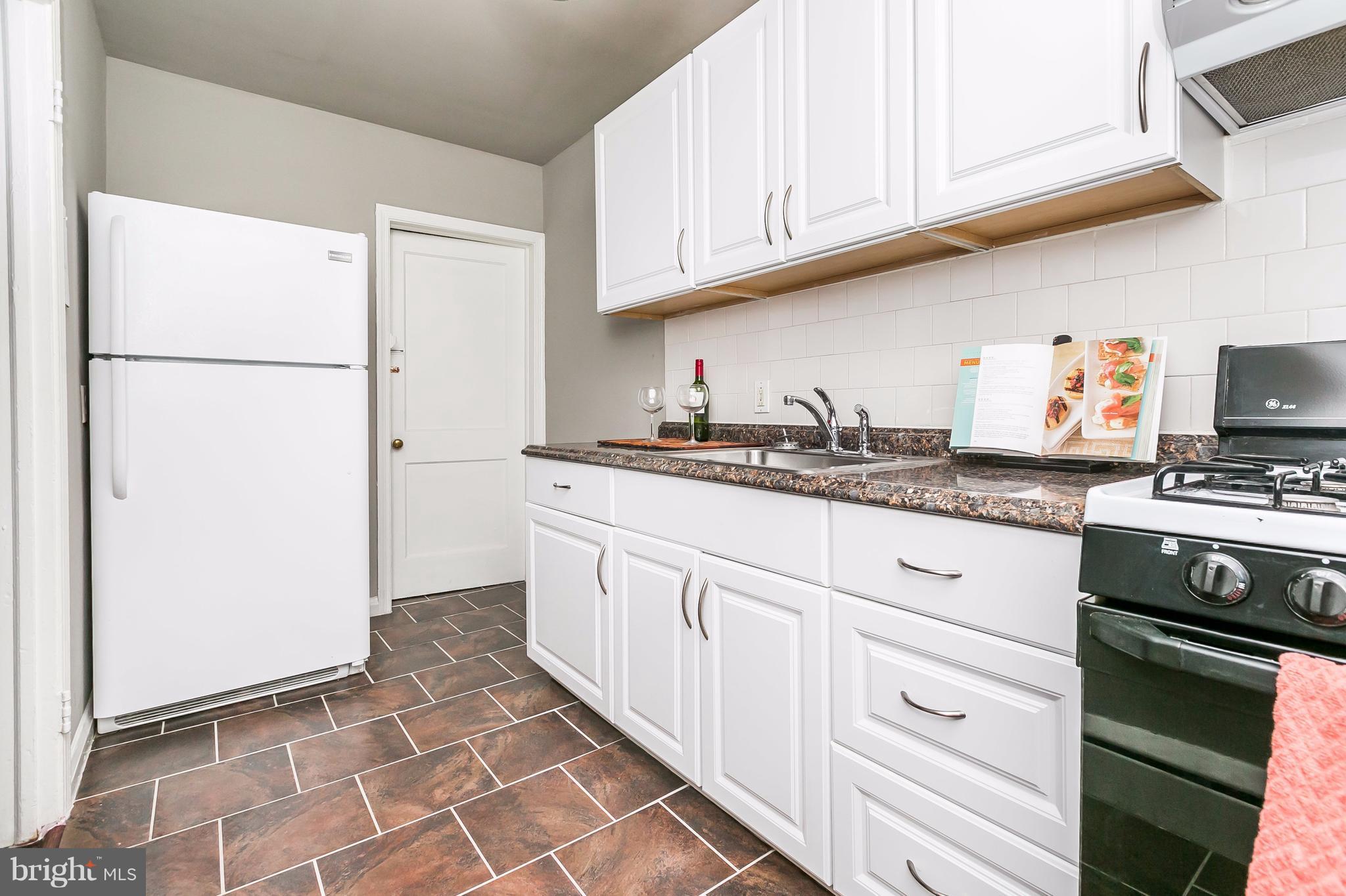 4016 Rexmere Road Baltimore, MD 21218 - Photo 5 of 26 a kitchen with stainless steel appliances granite countertop a refrigerator sink and cabinets