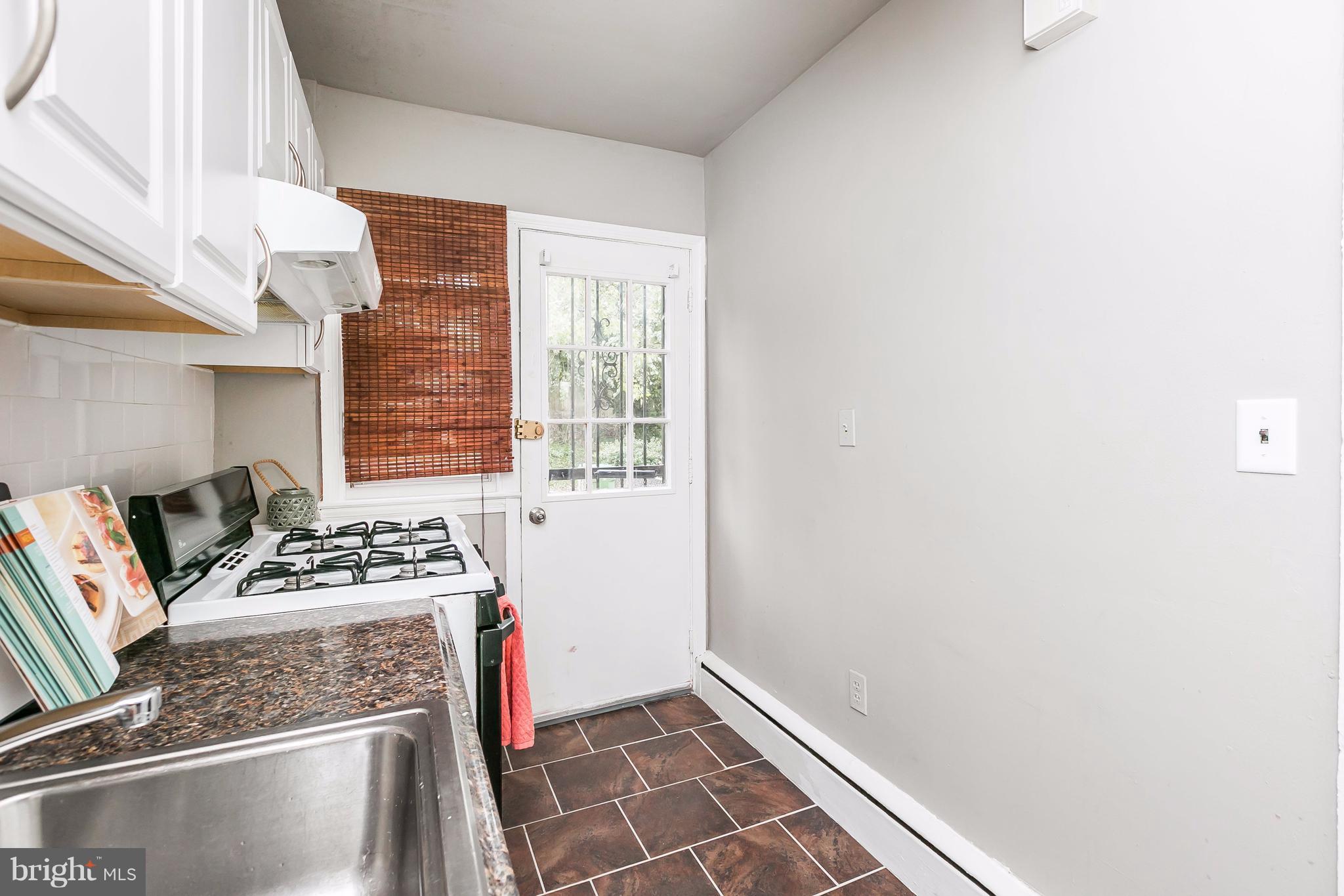 4016 Rexmere Road Baltimore, MD 21218 - Photo 7 of 26 a kitchen with a stove and a window