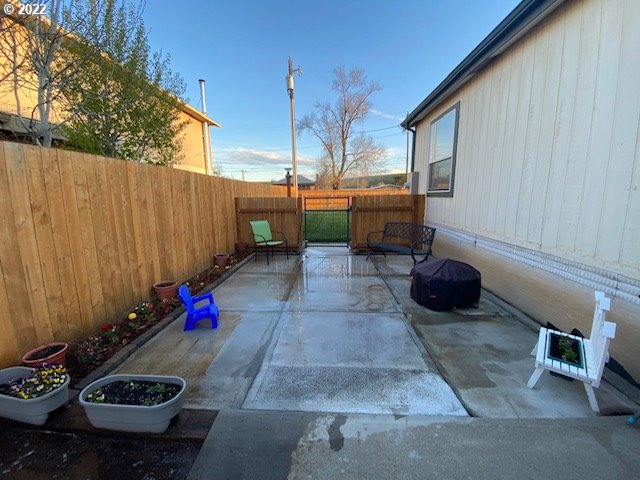 3425 Northeast Riverside Avenue Pendleton, OR 97801 - Photo 4 of 25 a view of a backyard with table and chairs and potted plants
