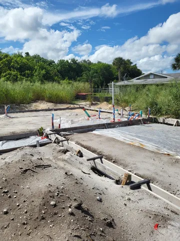 a view of a yard with wooden fence
