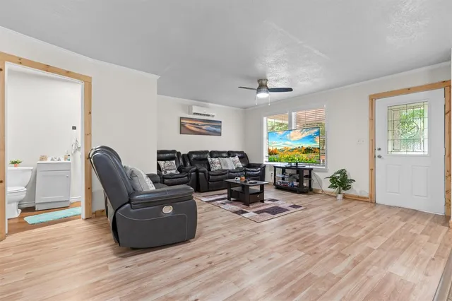 a living room with furniture and wooden floor