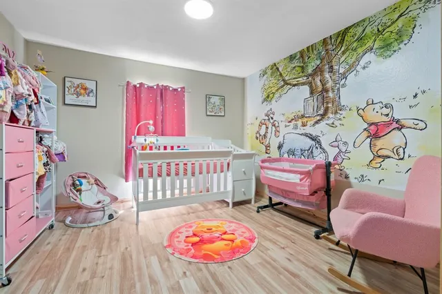 a bedroom with furniture and a wooden floor