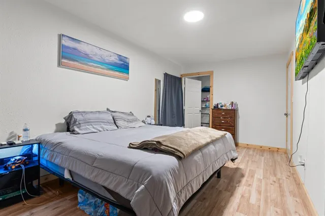 a bedroom with a bed and a flat screen tv