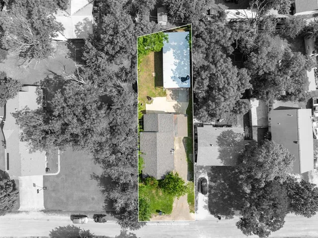 an aerial view of a house with a yard and garden