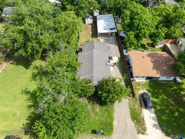 an aerial view of a house with a yard