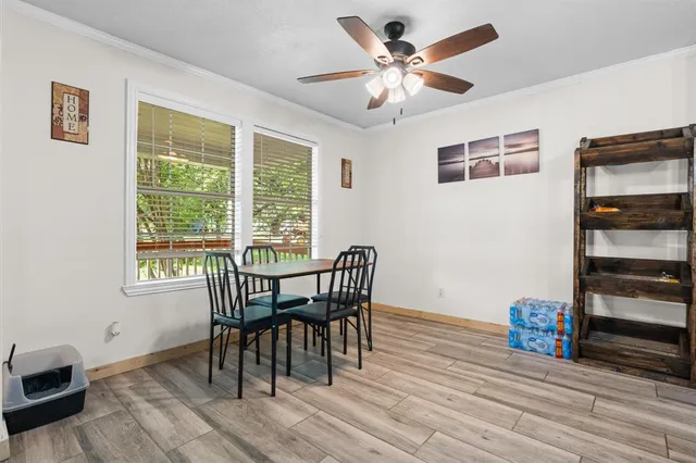 a view of a dining room with furniture window and wooden floor