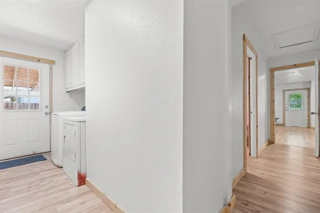 a view of a hallway with wooden floor and closet