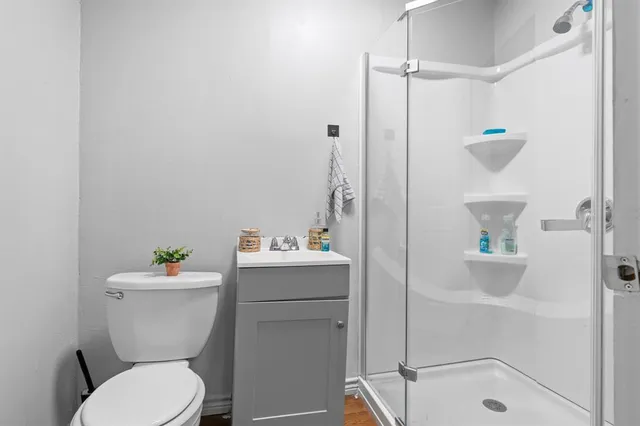 a white toilet sitting next to a bathroom sink