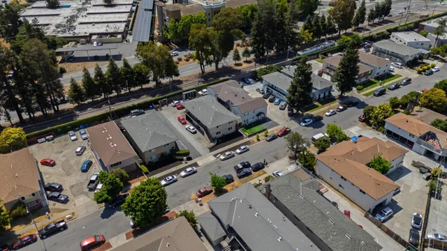 an aerial view of residential houses with outdoor space