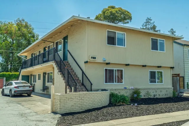 a front view of a house with stairs