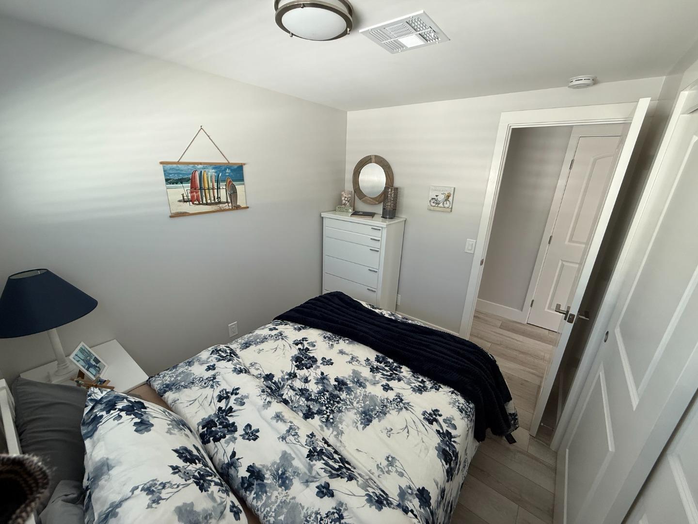 8 Lighthouse Road, Unit 8 Half Moon Bay, CA 94019 - Photo 7 of 21 a bedroom with a bed and white cabinets