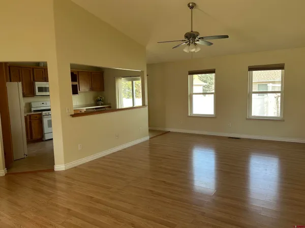 a furnished livingroom with a window and a view of chair