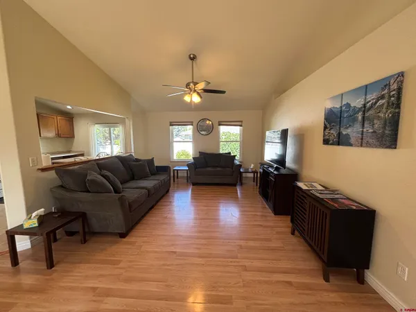 a view of a room with a ceiling fan and closet