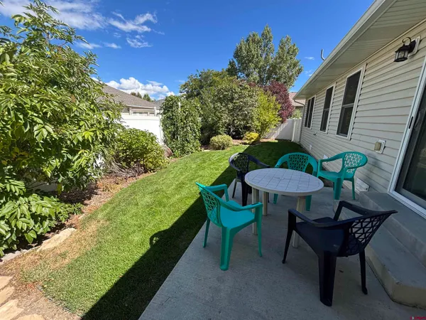 a view of a house with backyard and sitting area