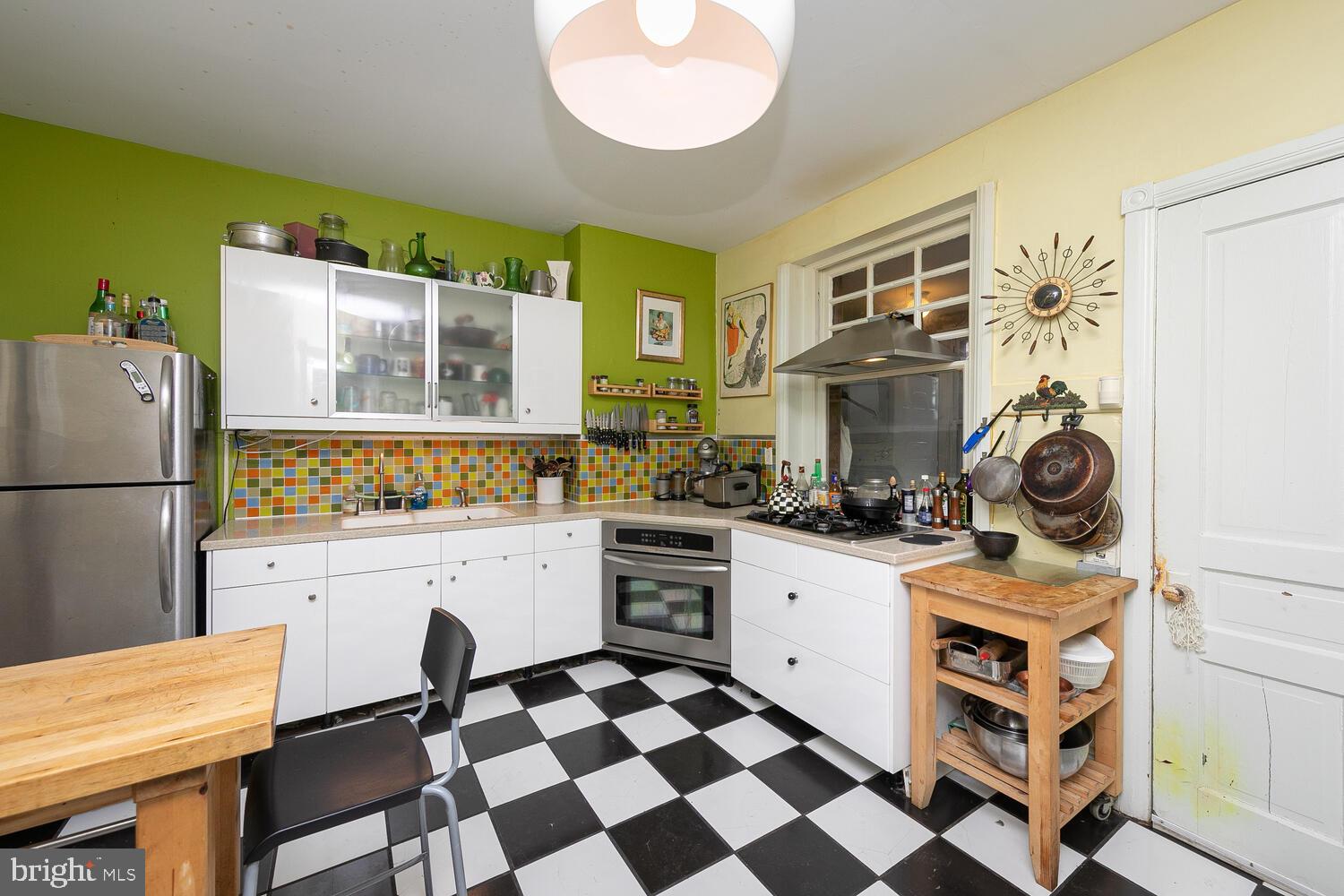 6705 Cresheim Road Philadelphia, PA 19119 - Photo 11 of 36 a kitchen with a stove a sink and a refrigerator