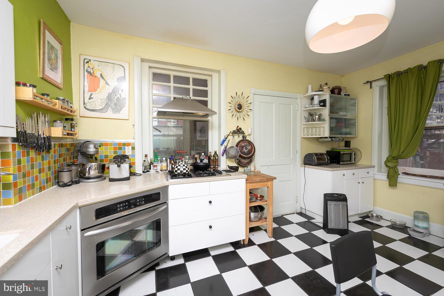 6705 Cresheim Road Philadelphia, PA 19119 - Photo 12 of 36 a kitchen with a stove and a white cabinets