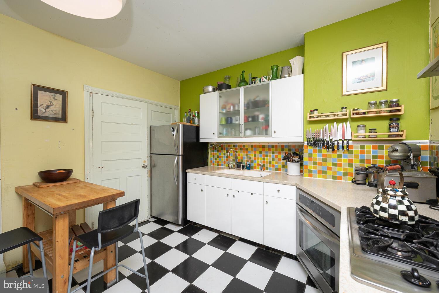 6705 Cresheim Road Philadelphia, PA 19119 - Photo 13 of 36 a kitchen with a refrigerator and a stove top oven