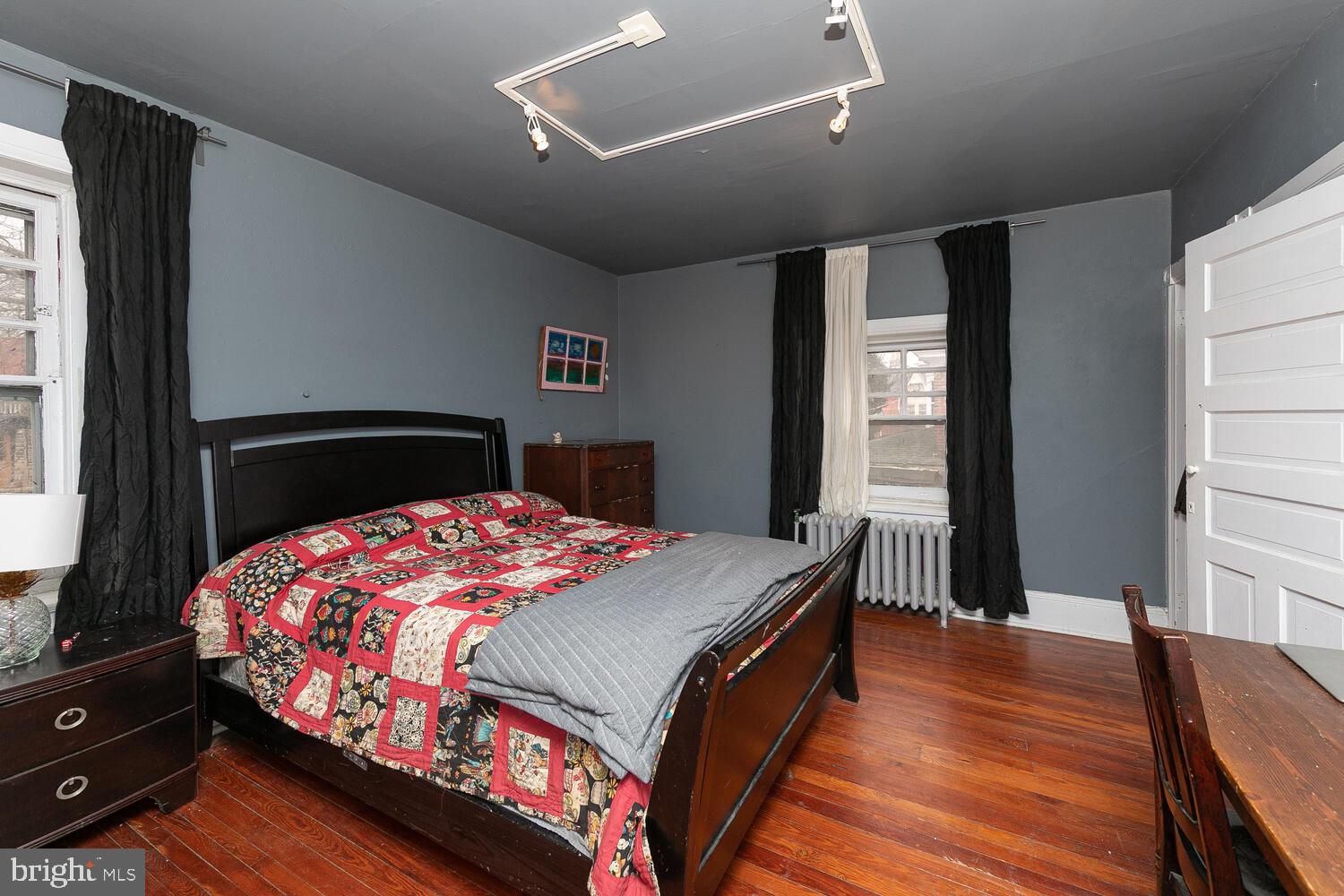 6705 Cresheim Road Philadelphia, PA 19119 - Photo 19 of 36 a bedroom with a bed and wooden floor
