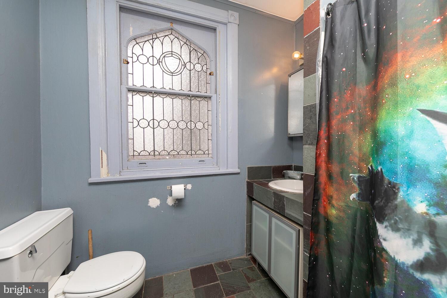 6705 Cresheim Road Philadelphia, PA 19119 - Photo 21 of 36 a bathroom with a granite countertop toilet sink and mirror