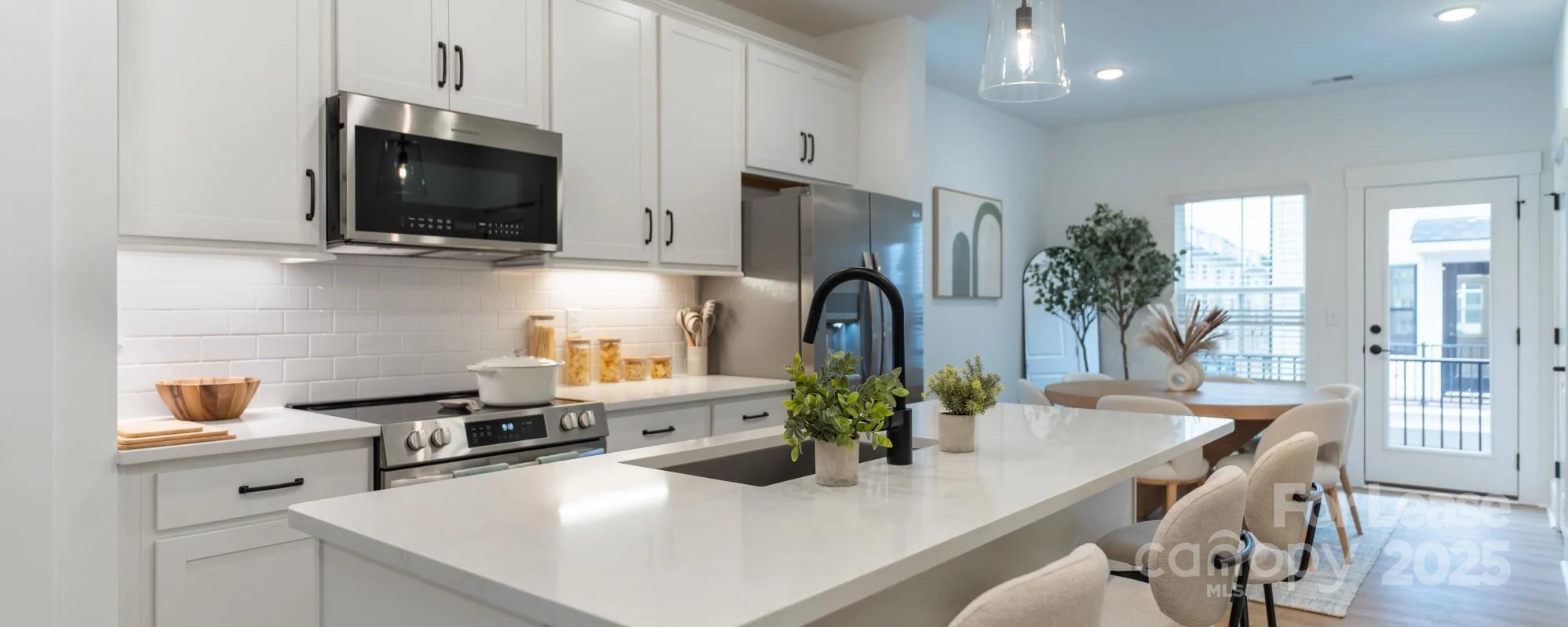 2713 Rozzelles Ferry Road Charlotte, NC 28208 - Photo 15 of 25 a kitchen with stainless steel appliances a stove a sink a microwave and cabinets