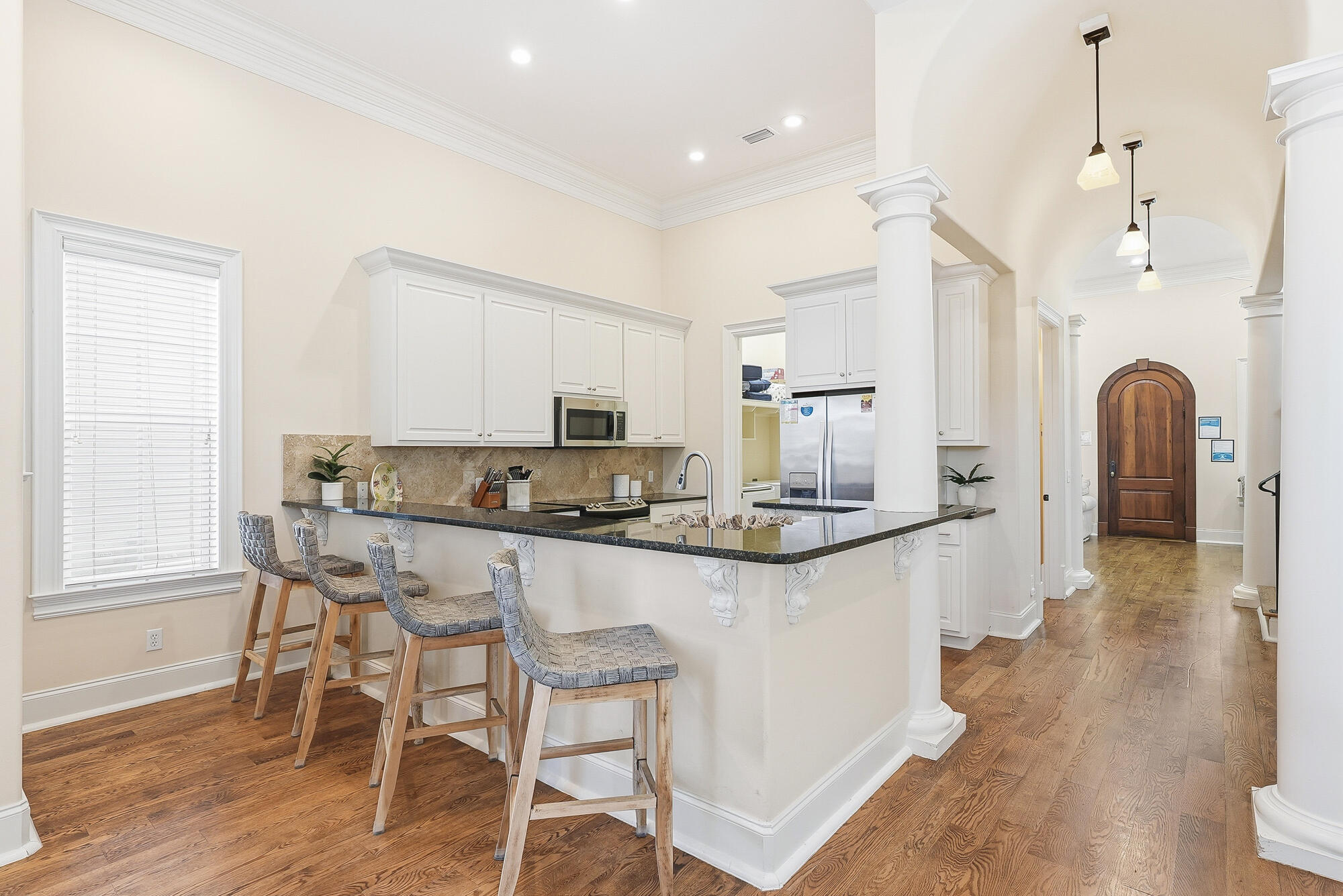 156 Palmeira Way Santa Rosa Beach, FL 32459 - Photo 11 of 58 a kitchen with kitchen island granite countertop a table chairs refrigerator and microwave