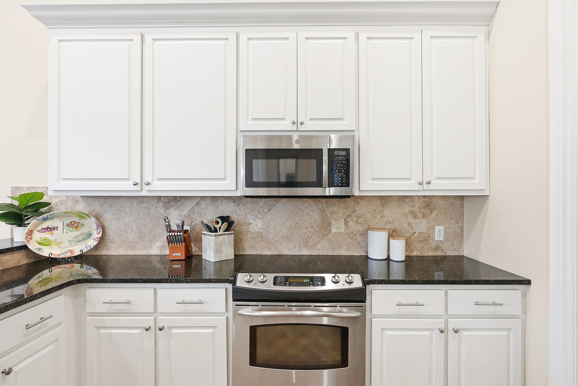 156 Palmeira Way Santa Rosa Beach, FL 32459 - Photo 12 of 58 a kitchen with granite countertop white cabinets and white appliances