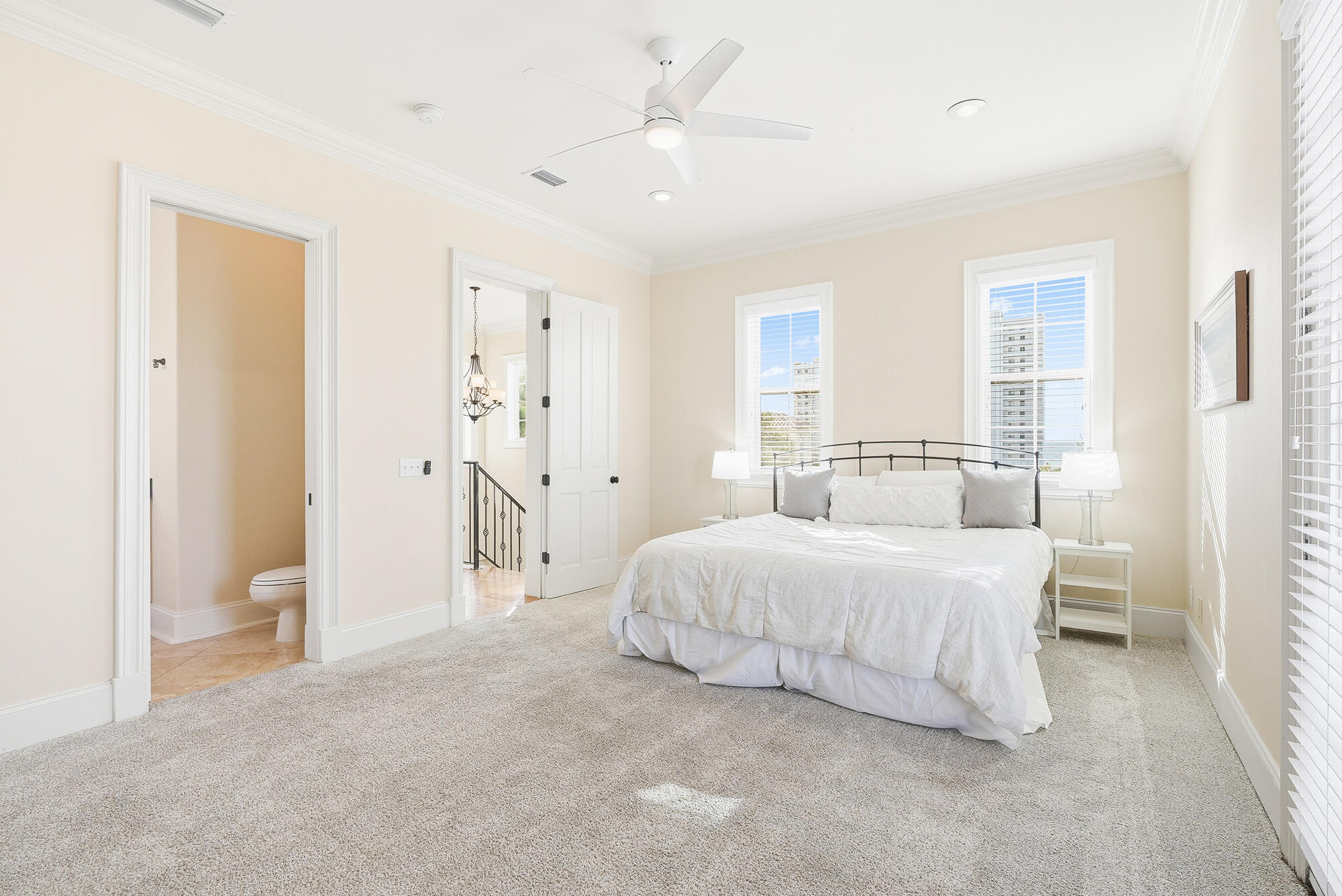 156 Palmeira Way Santa Rosa Beach, FL 32459 - Photo 30 of 58 a spacious bedroom with a bed and a chandelier