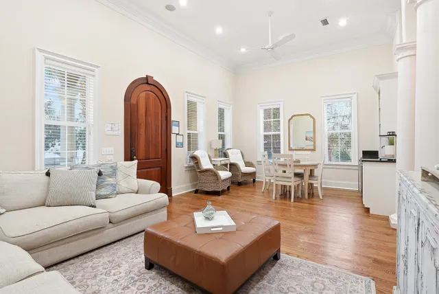 a view of a dining room with furniture a chandelier and wooden floor
