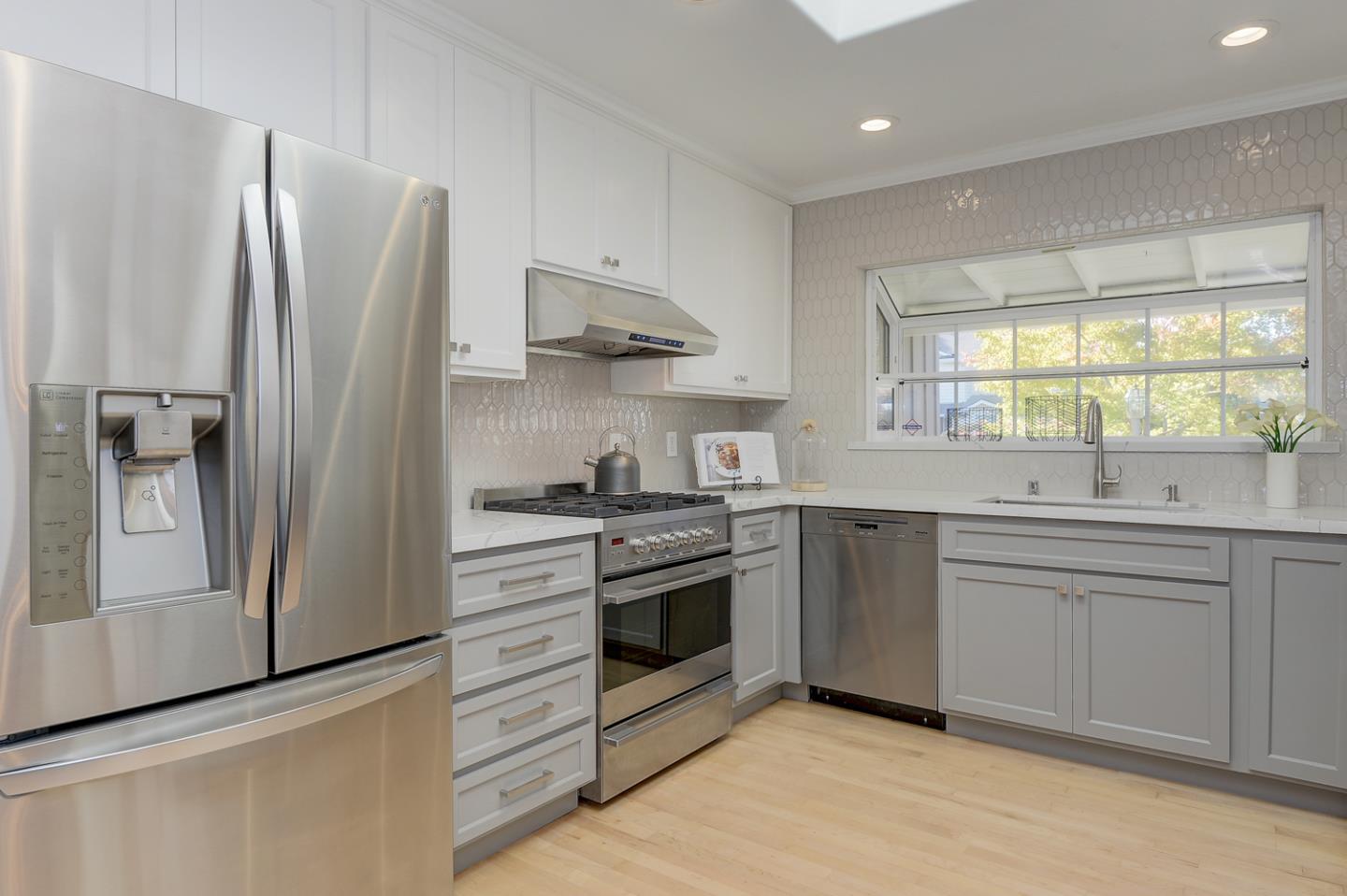 1445 Meadow Lane Mountain View, CA 94040 - Photo 12 of 33 a kitchen with stainless steel appliances white cabinets and a refrigerator