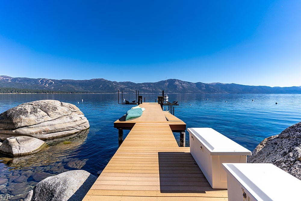 a view of balcony with wooden floor and mountain view