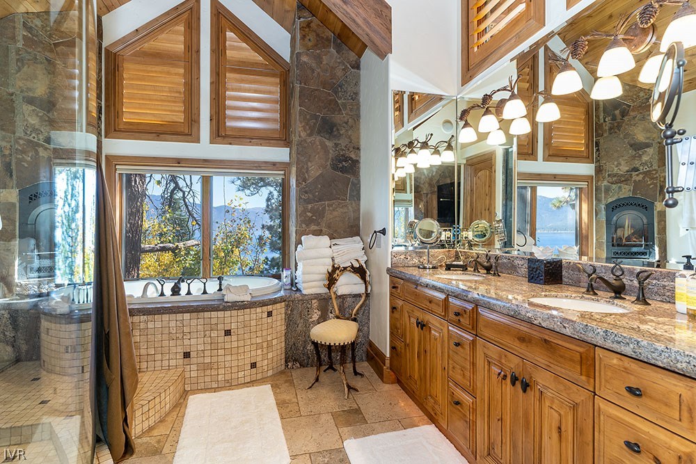 444 Gonowabie Road Crystal Bay, NV 89402 - Photo 17 of 35 a spacious bathroom with a granite countertop sink and a large mirror