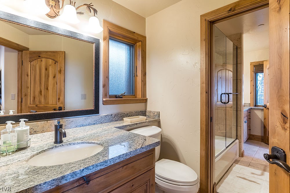 444 Gonowabie Road Crystal Bay, NV 89402 - Photo 25 of 35 a bathroom with a granite countertop sink toilet a mirror and shower