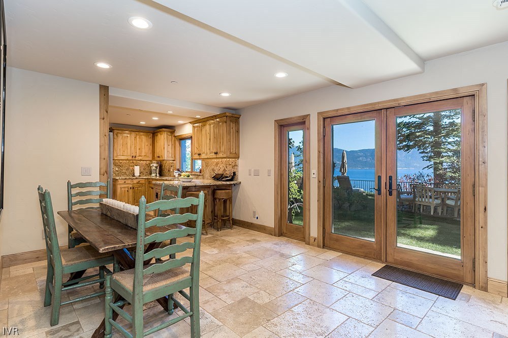 444 Gonowabie Road Crystal Bay, NV 89402 - Photo 26 of 35 a view of a dining room and livingroom with furniture a rug a flat screen tv and a painting