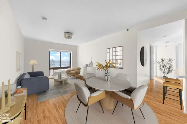 a dining room with furniture and wooden floor