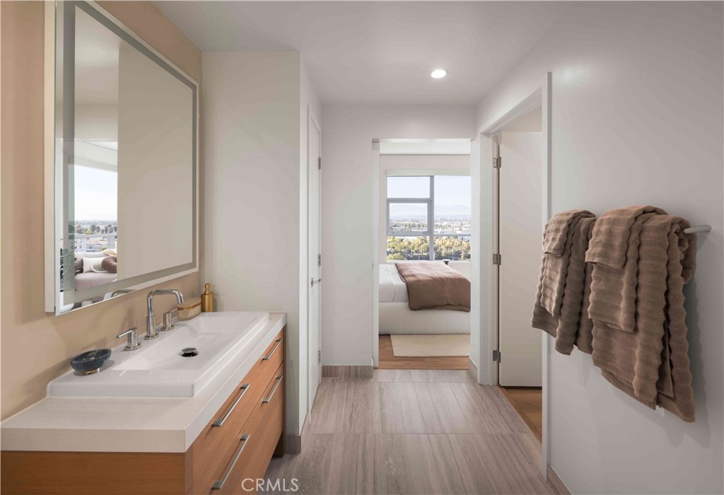 9 Mac Arthur Place, Unit 807 Santa Ana, CA 92707 - Photo 4 of 13 a en suite bathroom with a double vanity sink and mirror