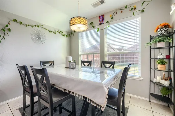 a view of a dining room and livingroom with furniture wooden floor and a chandelier