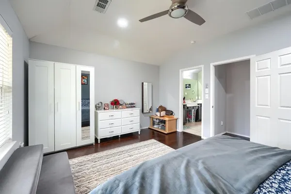 a bedroom with a bed and a dresser