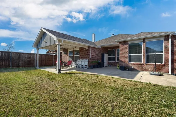 a view of a house with a backyard porch and sitting area