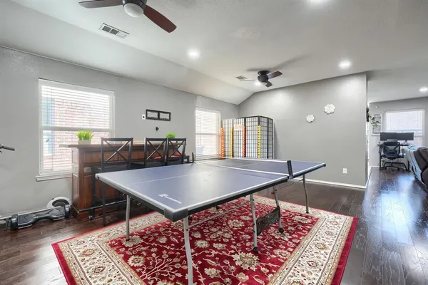 a room with furniture pool table and windows