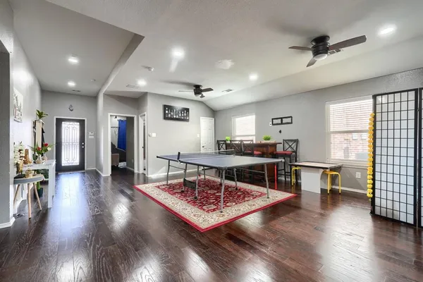 a living room with furniture a window and wooden floor