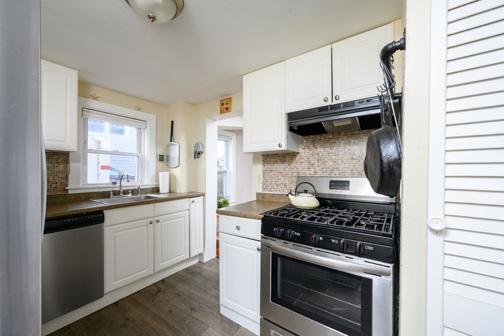 134 Hampton Circle Hull, MA 02045 - Photo 14 of 41 a kitchen with stainless steel appliances granite countertop a stove and a microwave