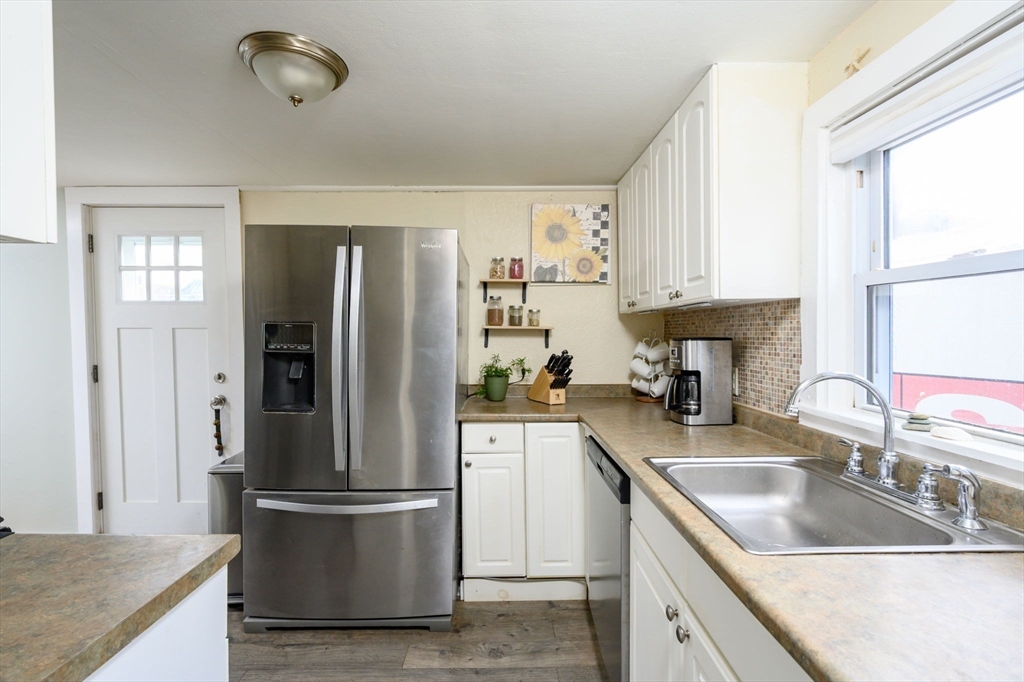 134 Hampton Circle Hull, MA 02045 - Photo 15 of 41 a kitchen with stainless steel appliances granite countertop a refrigerator a sink a stove and white cabinets
