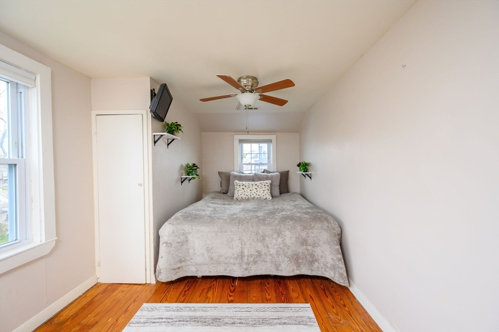 134 Hampton Circle Hull, MA 02045 - Photo 23 of 41 a bedroom with a bed and wooden floor