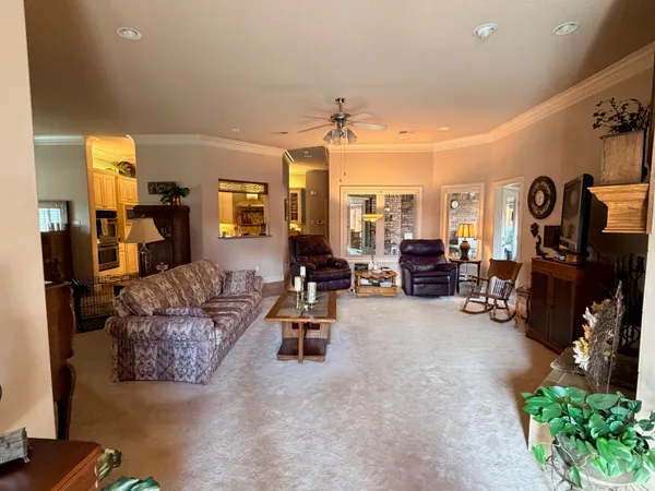 a living room with furniture a fireplace and a window