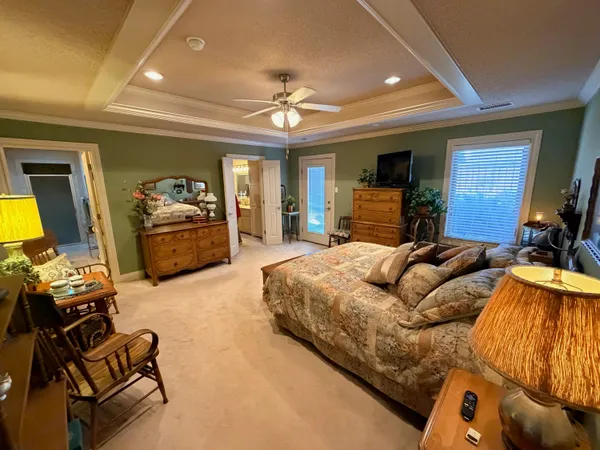 a white toilet sitting next to a bathroom sink and a mirror