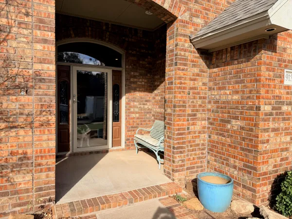 a view of a patio with table and chairs and potted plants